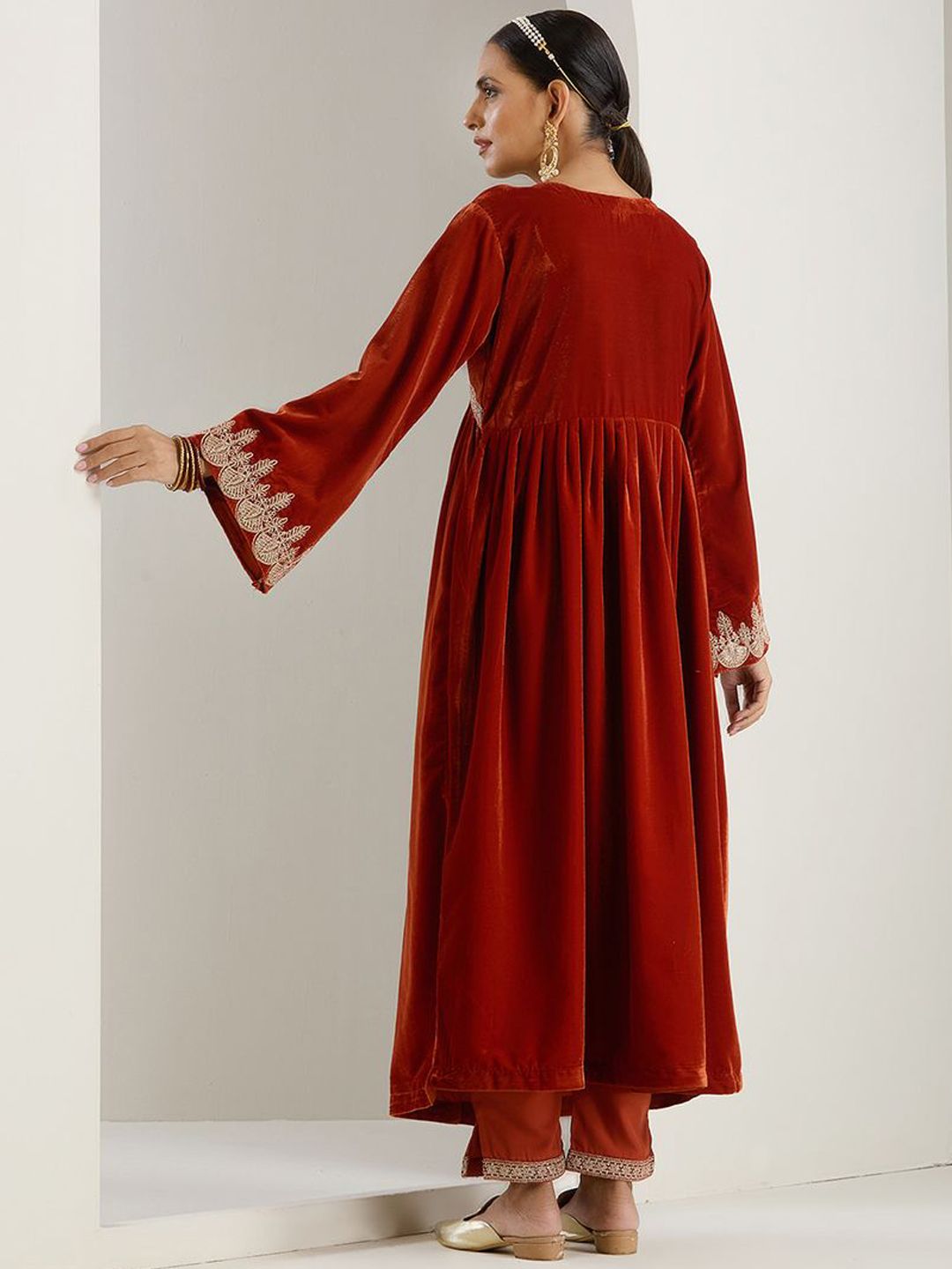 Rich Velvet Gold Zari Embroidered Rust A-Line Kurta Set With Straight Bottom & Scalloped Sleeves.