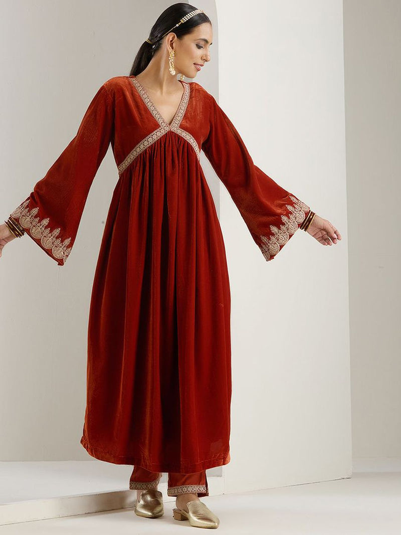 Rich Velvet Gold Zari Embroidered Rust A-Line Kurta Set With Straight Bottom & Scalloped Sleeves.