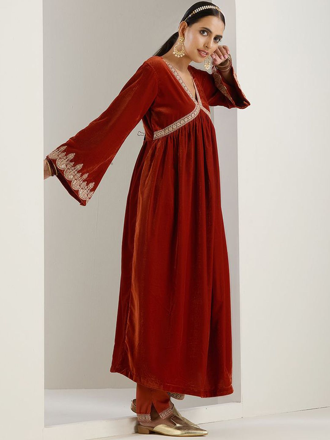 Rich Velvet Gold Zari Embroidered Rust A-Line Kurta Set With Straight Bottom & Scalloped Sleeves.